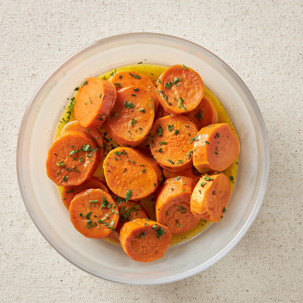 Effortlessly prepared Maple Candied Sweet Potatoes made and served in the glass Anyday dish, featuring tender sweet potato slices coated in a rich maple butter glaze. This method ensures evenly cooked sweet potatoes, perfect for a sweet and savory side dish.