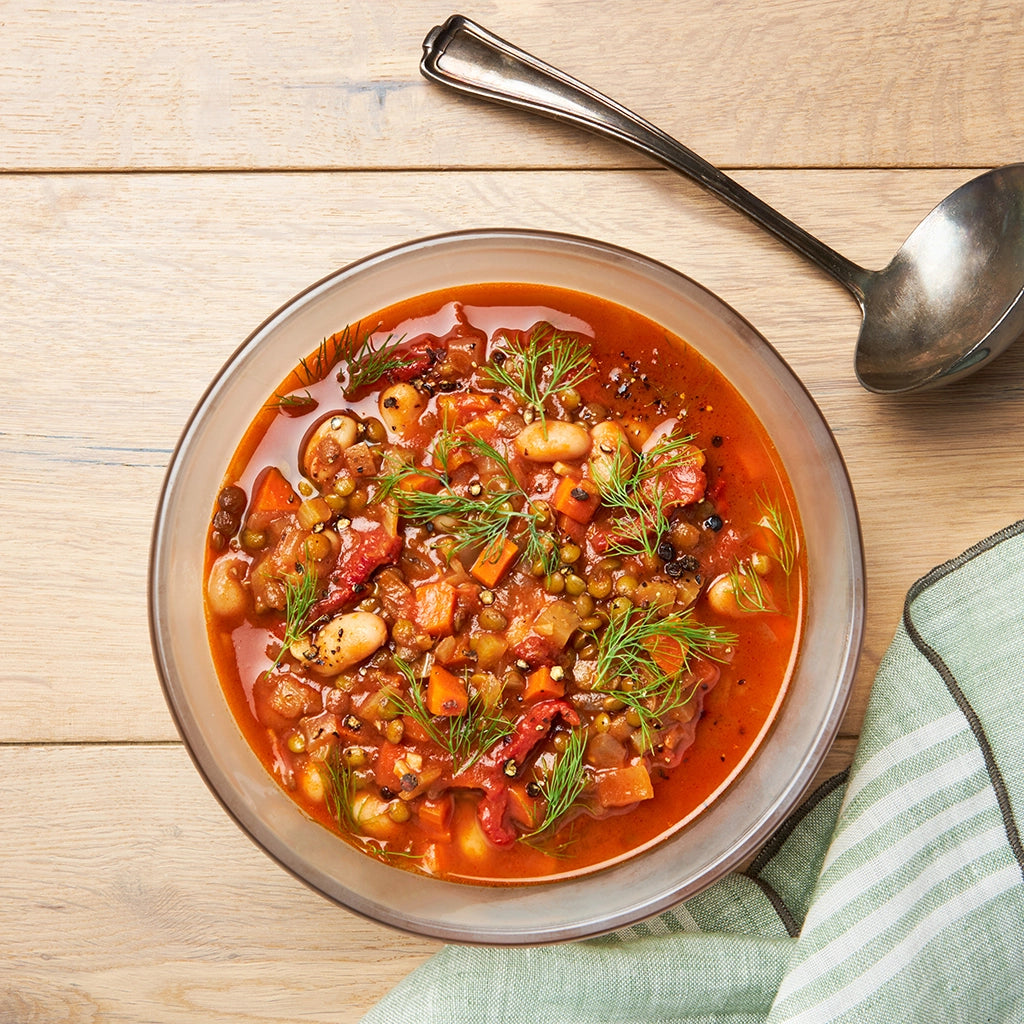 Family-friendly Mediterranean-Style Lentil Soup made in the glass Anyday dish, consisting of green or brown lentils, sun-dried tomatoes, and cannellini beans. This method ensures a hearty and flavorful soup, perfect for a quick and nutritious meal.