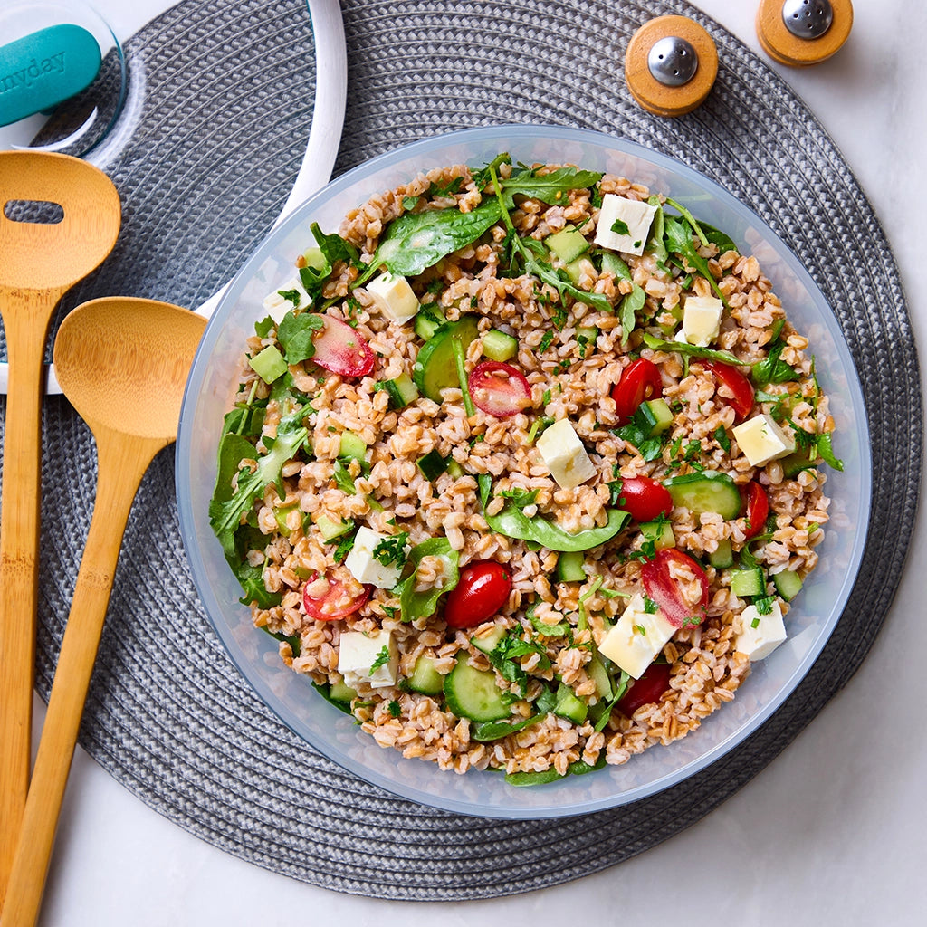 Flavorful Mediterranean Grain Salad made in the glass Anyday dish, consisting of nutty farro, cherry tomatoes, cucumber, feta cheese, and fresh greens. This method ensures perfectly cooked grains, perfect for a refreshing and nutritious side dish or meal.