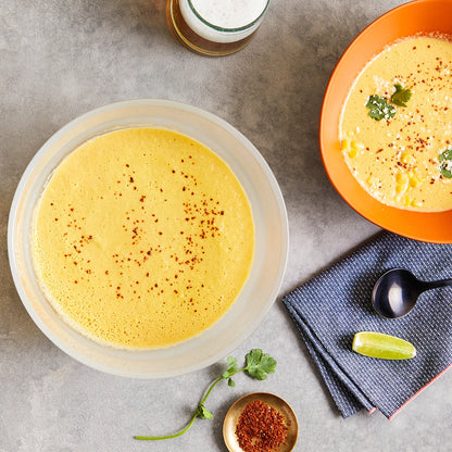 Simple Mexican Street Corn Soup made in the glass Anyday dish, consisting of sweet corn, red onion, chipotle peppers, and cotija cheese. This method ensures a rich and flavorful soup, perfect for a comforting and spicy meal.