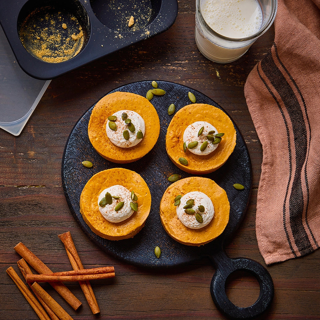 Perfectly cooked mini pumpkin pies made in the Anytime Freezer Trays, featuring a rich and creamy pumpkin filling spiced with cinnamon, nutmeg, and cloves. These delicious, single-serving pies are ideal for a festive dessert, offering a quick and easy way to enjoy a classic fall treat made in the microwave.