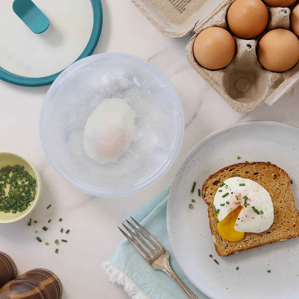 Perfectly cooked poached eggs made and served in the glass Anyday dish, providing tender and evenly cooked eggs. This method ensures quick and easy poached eggs, ideal for breakfast or adding to various dishes.