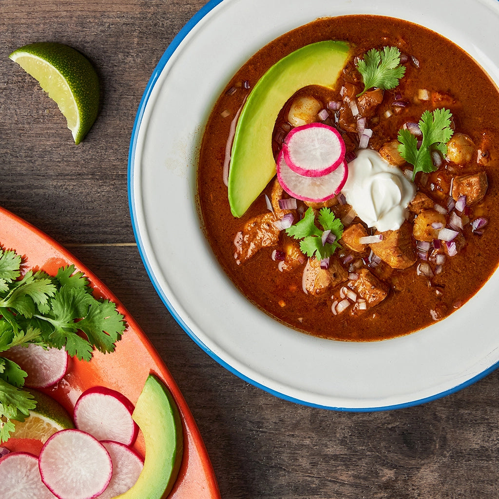 Flavorful Pozole Rojo made in the glass Anyday dish, featuring tender pork, hominy, and a rich red chili broth. This quick and easy microwave recipe delivers a traditional Mexican soup with a delicious blend of savory and spicy flavors, perfect for a hearty and satisfying meal.