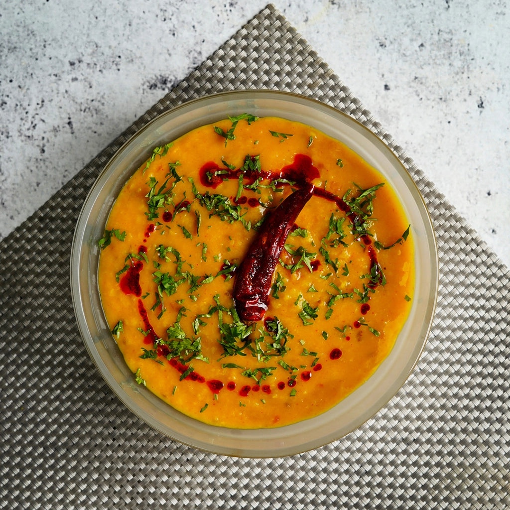 Flavorful microwave dal made in the glass Anyday dish, featuring lentils cooked with aromatic spices and herbs. This quick and easy recipe by Priya Krishna delivers a comforting and nutritious Indian dish, perfect for a satisfying meal.