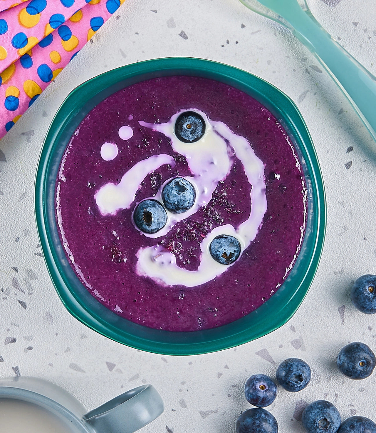 Vibrant purple porridge made in the glass Anyday dish, featuring a blend of oats and nutrient-rich blueberries. This quick and easy microwave recipe delivers a creamy and colorful breakfast, perfect for a nutritious and visually appealing start to a baby's day.