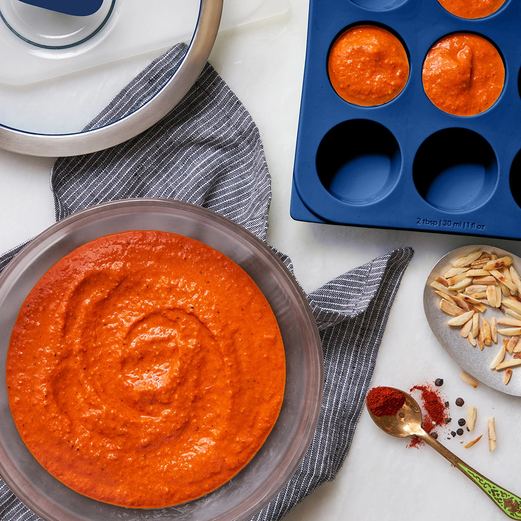 Flavorful Romesco sauce made in the glass Anyday dish, featuring roasted red peppers, tomatoes, almonds, and garlic blended to smooth perfection. This quick and easy microwave recipe delivers a rich and versatile sauce, perfect for pairing with meats, vegetables, or as a dip.