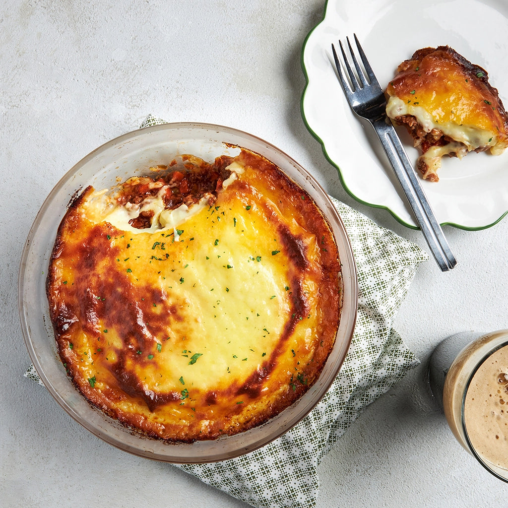 Perfectly layered shepherd's pie cooked in the microwave using the glass Anyday dish, featuring a savory filling topped with creamy mashed potatoes. Enjoy a comforting and hearty meal that's ready in minutes.