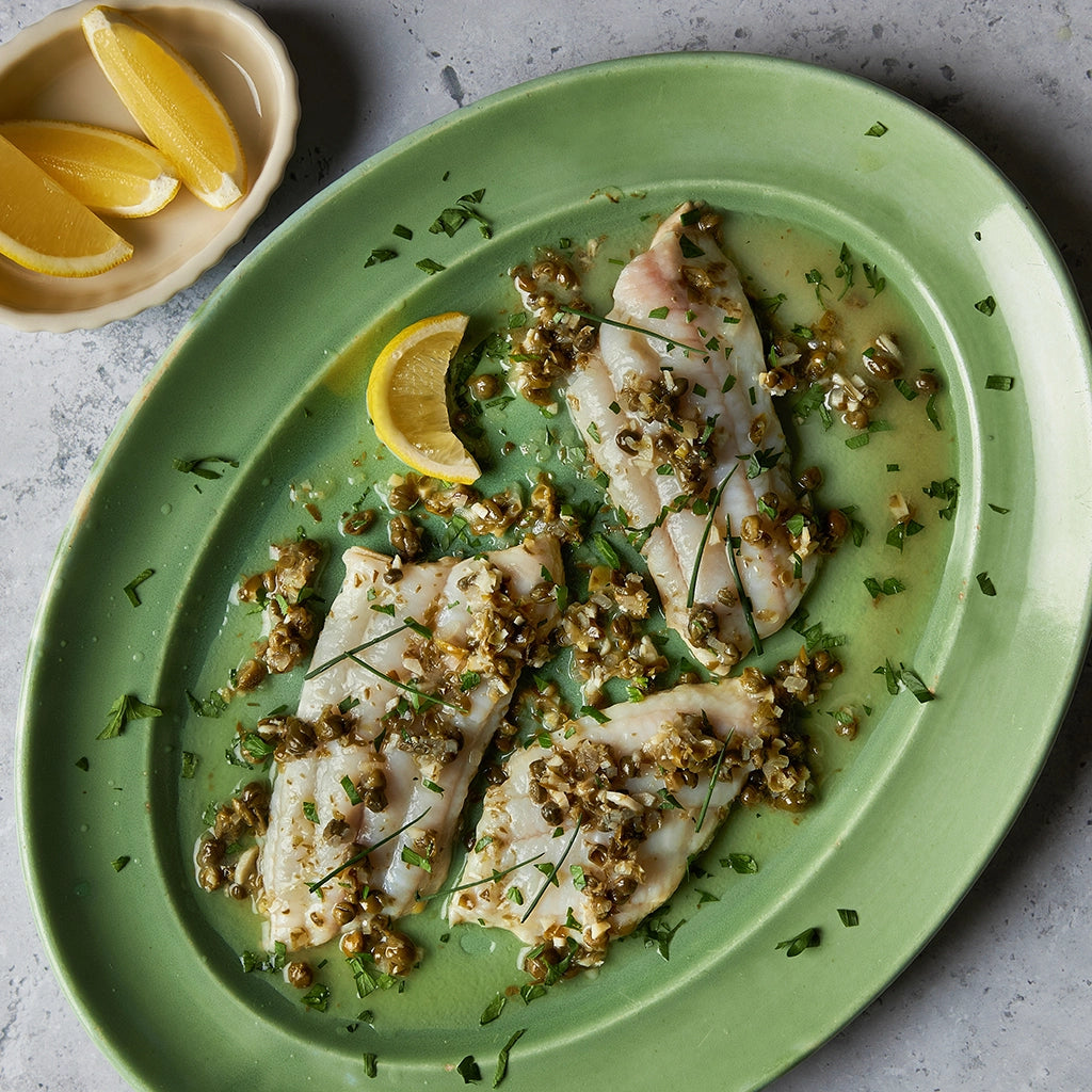 Delicately cooked sole with capers, butter, and lemon made in the microwave using the glass Anyday dish, ensuring perfectly tender fish with no unpleasant odors. Enjoy a quick and elegant meal with bright, zesty flavors, ready in minutes.