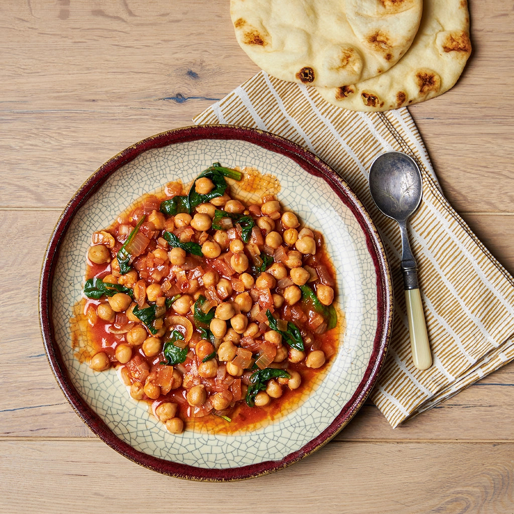 Spiced chickpeas and spinach cooked in the microwave using the glass Anyday dish, blending tender chickpeas with flavorful spices and wilted spinach. Enjoy a quick and nutritious plant-based meal, ready in minutes.