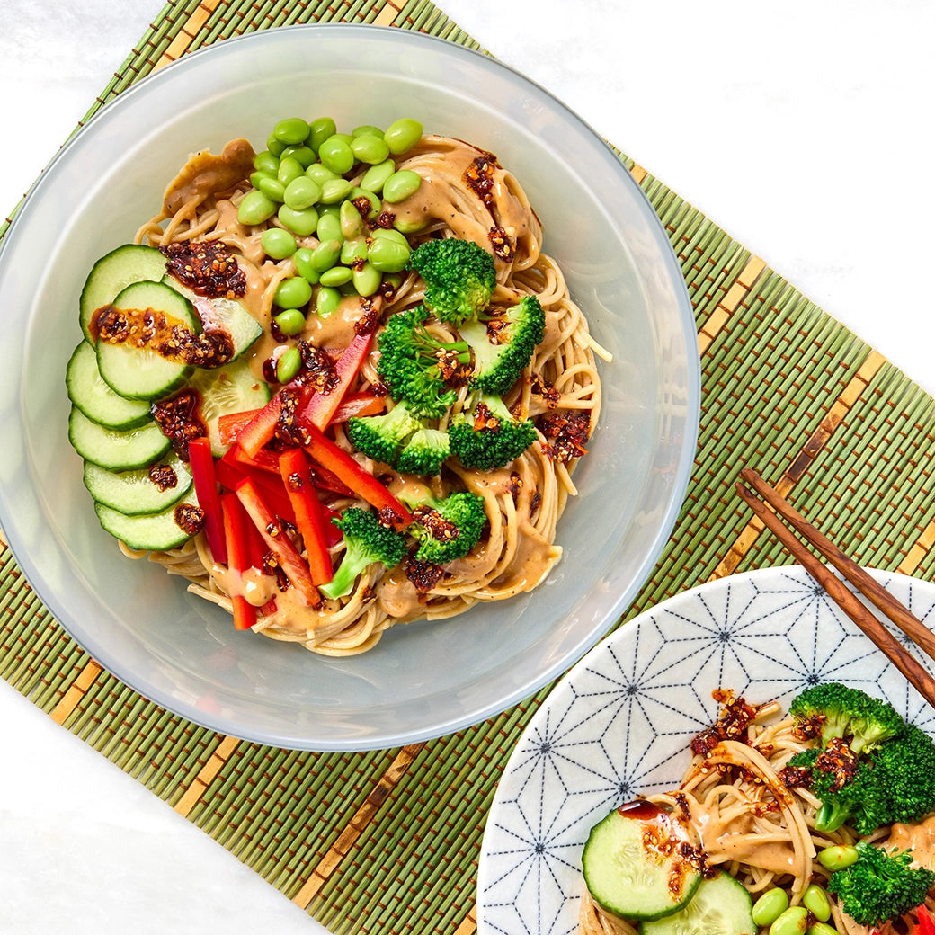 Spicy peanut noodle salad made in the microwave using the glass Anyday dish, combining perfectly cooked noodles with a tangy, spicy peanut sauce and crisp vegetables. No waiting for the water to boil—enjoy a quick and refreshing meal, ready in minutes.