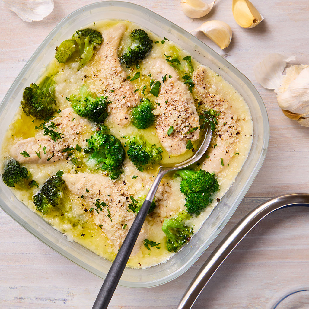 Garlicky creamy chicken with broccoli made in a square Anyday dish in the microwave, featuring tender chicken pieces cooked in a rich garlic cream sauce and paired with fresh broccoli. 