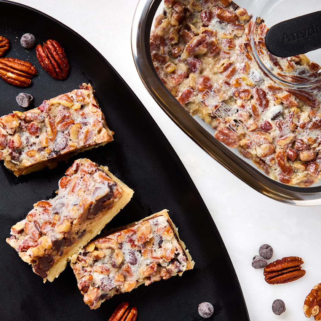 These maple ,pecan and chocolate bars with a shortbread base are made in a square Anyday dish in the microwave.  These indulgent bars are perfect for satisfying your sweet cravings.