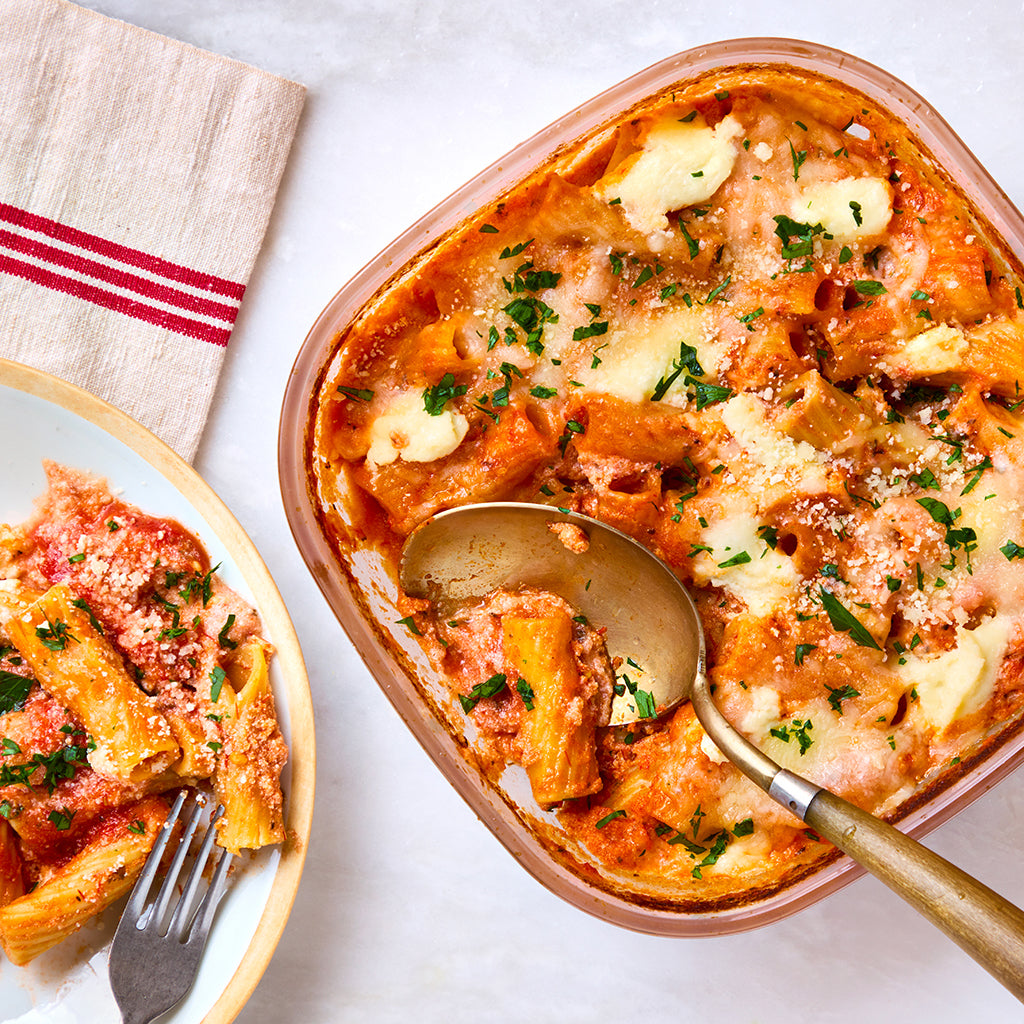 No-boil 'baked' ziti made in an Anyday square dish, featuring layers of pasta, marinara sauce, and melted cheese. This easy microwave recipe simplifies dinner prep, delivering a comforting, cheesy dish that's perfect for busy weeknights.