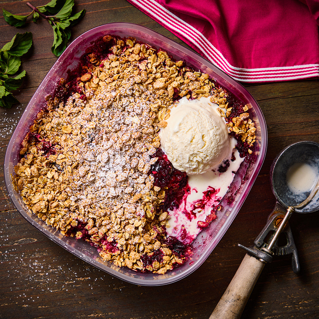 Mixed Berry Crisp made in an Anyday dish, showcasing a warm blend of blueberries, raspberries, and strawberries topped with a golden oat crumble. This easy microwave dessert is perfect for sharing and highlights the convenience of cooking with Anyday.