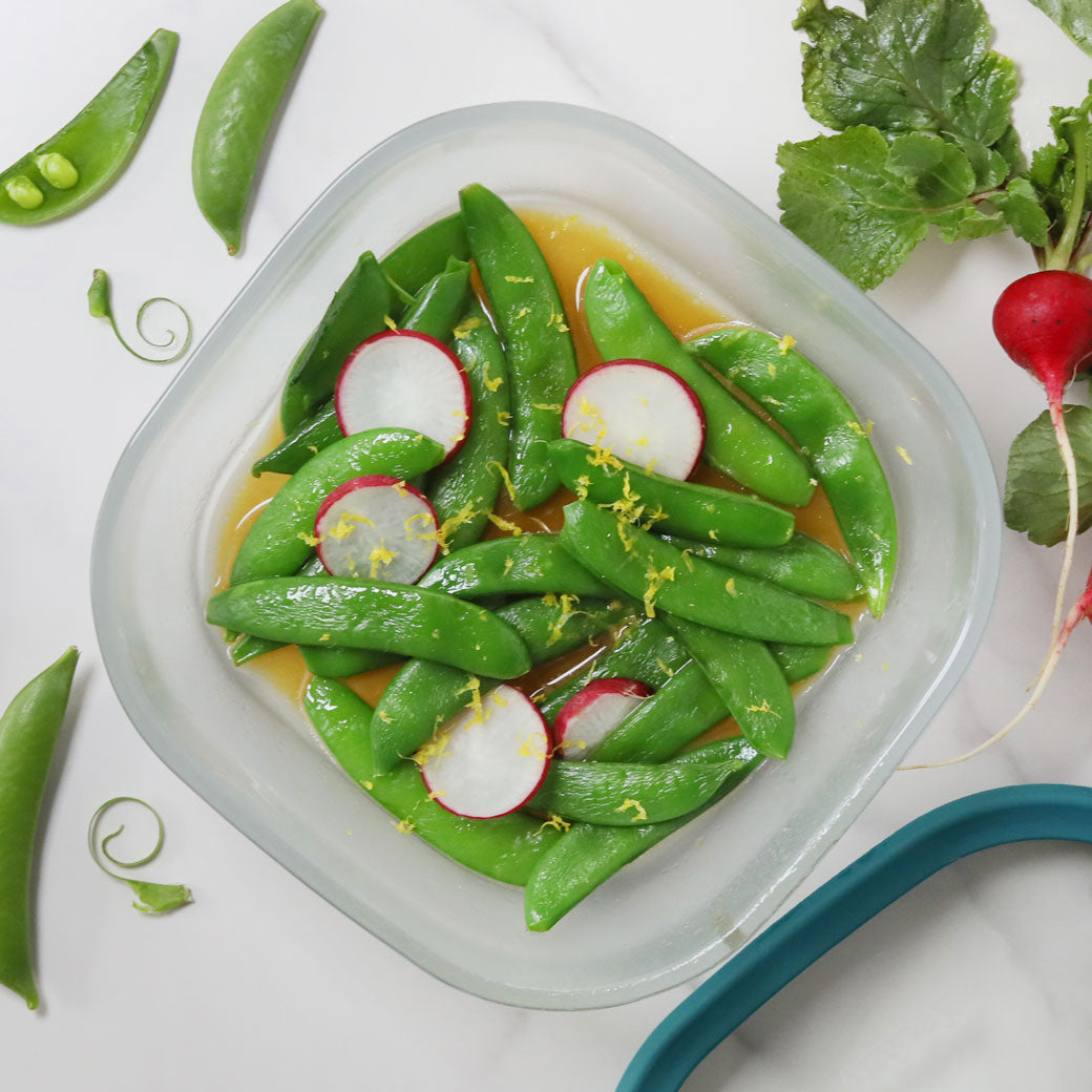 Crisp and tender sugar snap peas, prepared by Chef David Chang, cooked in the microwave using the glass Anyday dish, retaining their fresh flavor and vibrant color. Enjoy a quick and healthy side dish, ready in minutes.