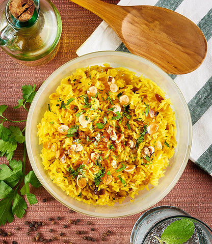 Turmeric rice pilaf with almonds cooked in the microwave using the glass Anyday dish, blending fragrant turmeric with fluffy rice and crunchy almonds. Enjoy a quick and vibrant side dish, ready in minutes.