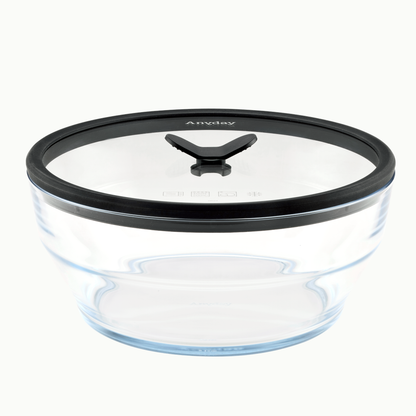 The Anyday 12-Cup Glass Round Deep Dish in Black Sesame is an empty, clear glass container with a black silicone lid featuring a central knob and the Anyday logo on top. Perfect for meal-prepping or storing large quantities of soup, the dish is showcased against a plain white background.
