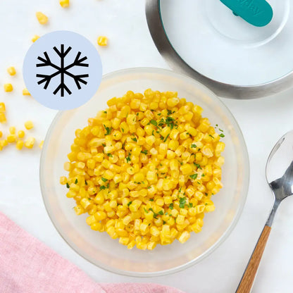 Frozen corn kernels in a clear Anyday dish, lightly steamed with lid nearby