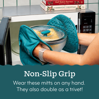 A person wearing teal silicone oven mitts removes an Anyday The Everything but the Microwave Bundle (kale) glass dish with a glass lid from a microwave.