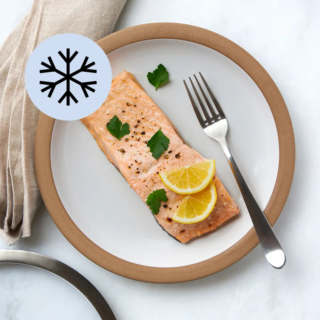 Perfectly cooked frozen salmon made and served in the glass Anyday dish, providing tender and flaky fish fillets. This method ensures evenly cooked salmon with no thawing needed, ideal for a quick and healthy main dish.