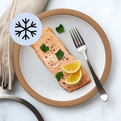 Frozen salmon fillet in a clear Anyday dish before cooking, with lid set to the side

