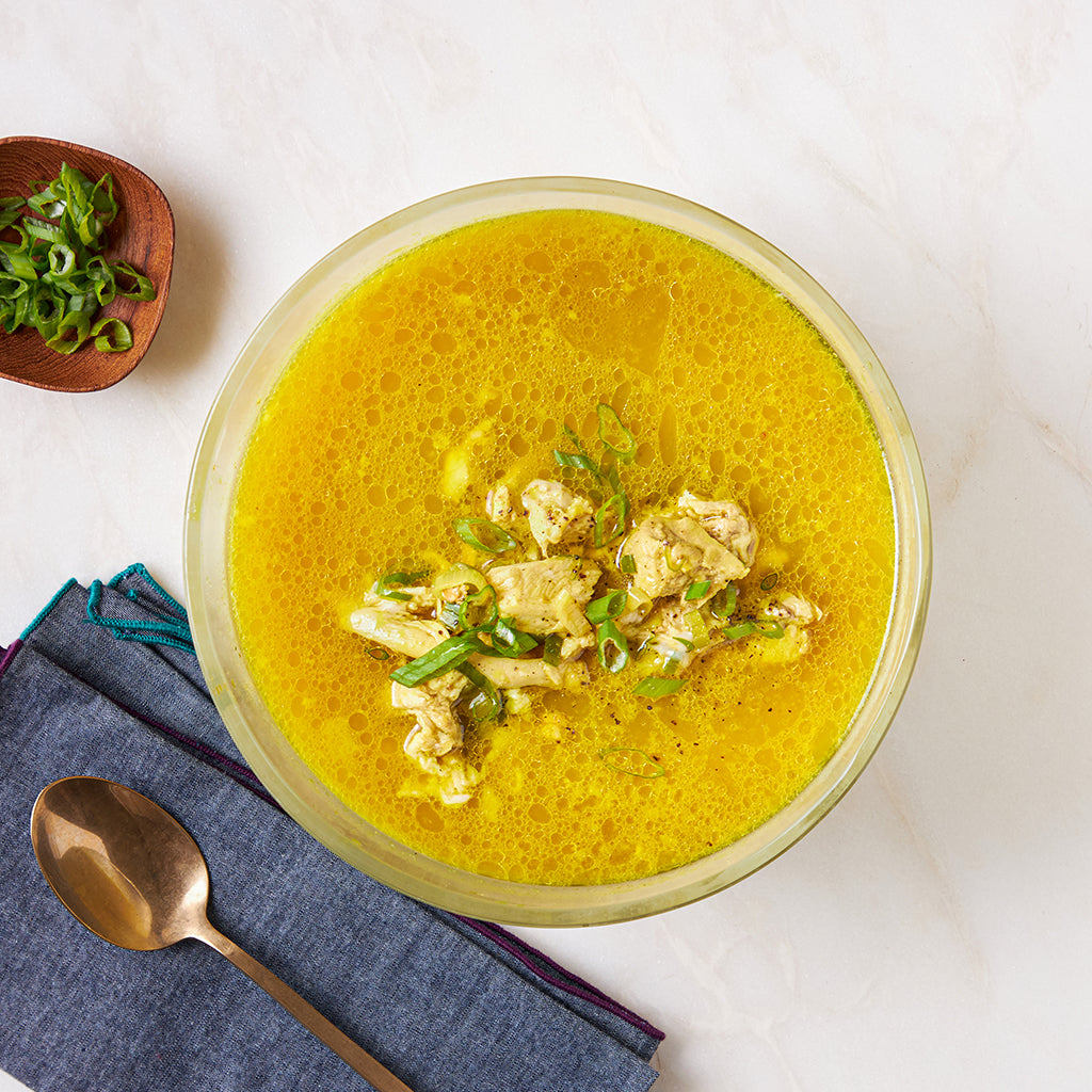 ChihYu Smith's Paleo Egg Drop Soup made and served in the glass Anyday dish, featuring delicate egg ribbons in a flavorful broth with green onions.